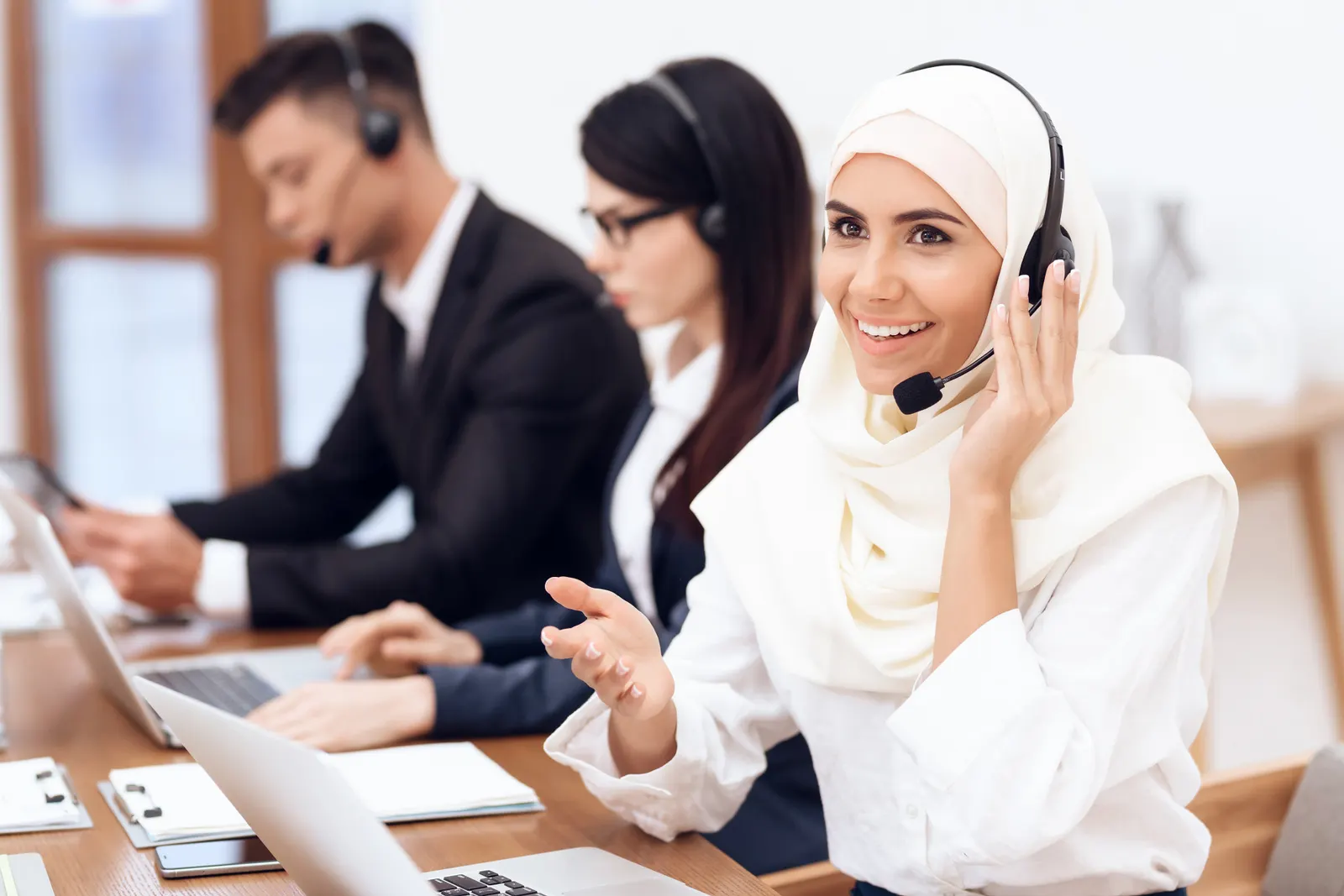 Team collaborating in an office with headsets