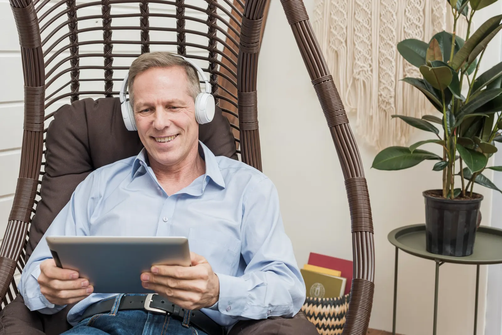 Person using a tablet outdoors with headphones